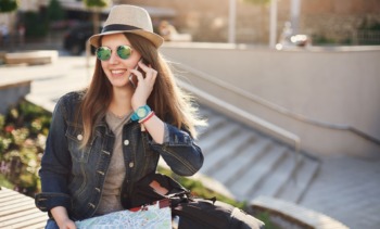 happy tourist talking phone holding map wearing jeans summer vacation its best min