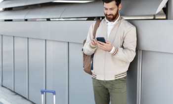 medium shot man holding smartphone min